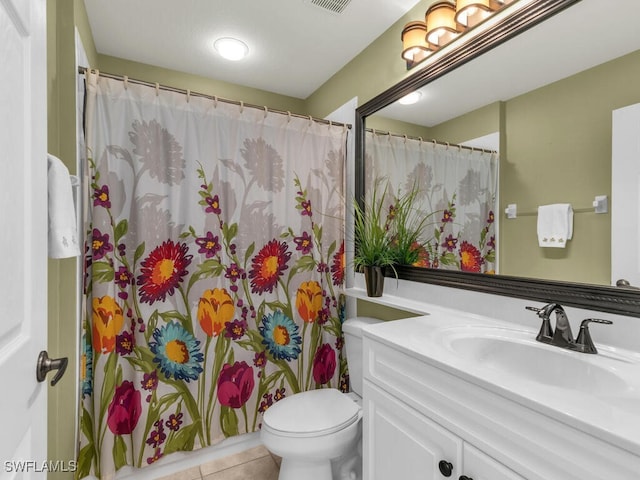 bathroom featuring a shower with shower curtain, vanity, toilet, and tile patterned floors