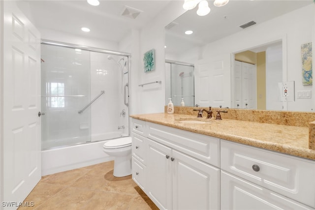 bathroom featuring toilet, visible vents, combined bath / shower with glass door, and vanity