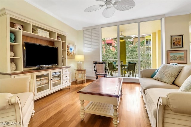 living room with a ceiling fan, floor to ceiling windows, and wood finished floors