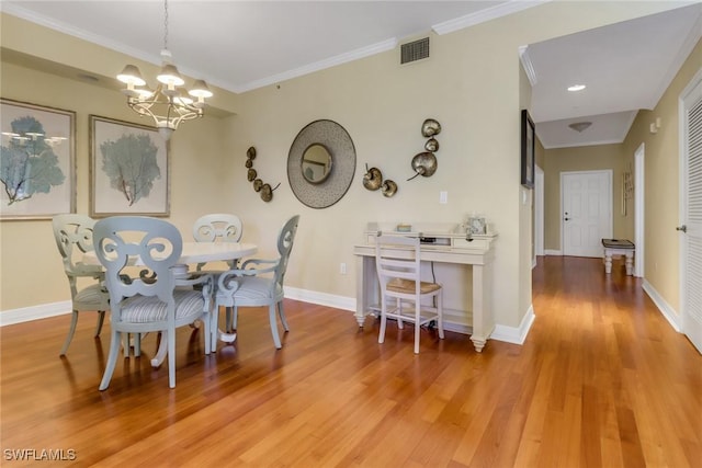 dining space with light wood-style flooring, visible vents, and crown molding