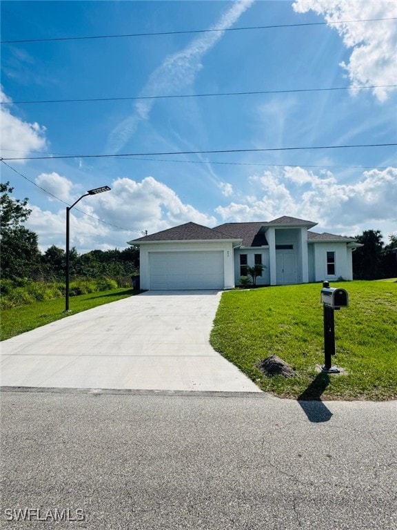 ranch-style home featuring a garage and a front yard