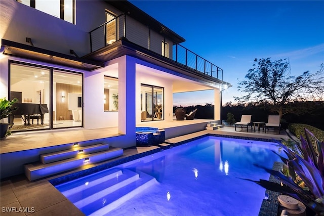 pool featuring a patio area and a jacuzzi