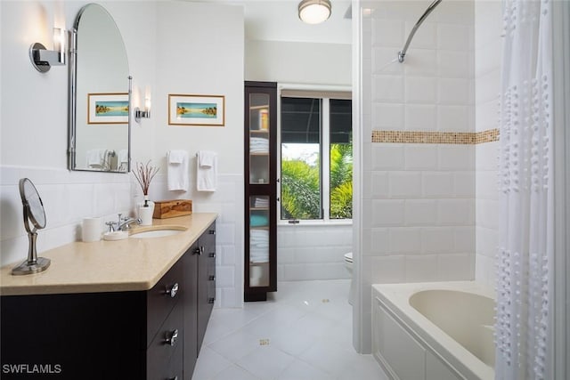 bathroom with toilet, vanity, tile walls, tile patterned floors, and shower / bath combination with curtain