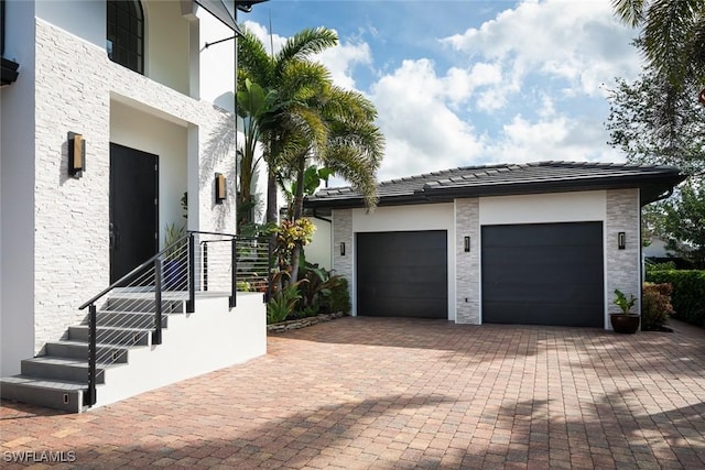 garage with decorative driveway