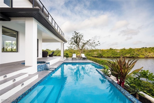 outdoor pool featuring a patio area and an in ground hot tub