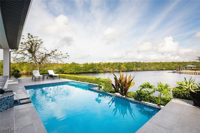 outdoor pool featuring a water view and a patio