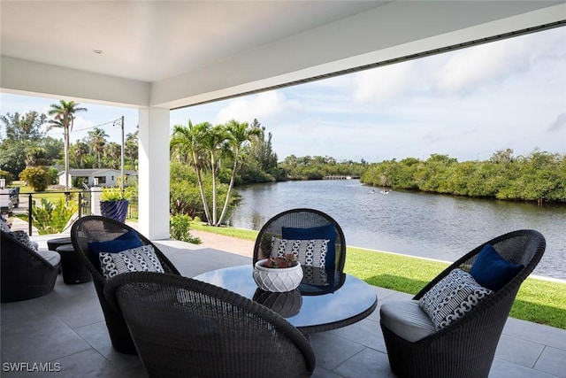 view of patio with a water view and an outdoor hangout area