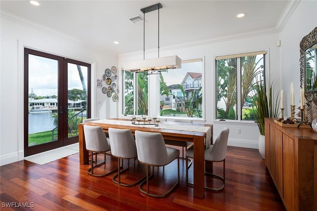 dining space featuring dark wood-style floors, french doors, visible vents, and crown molding