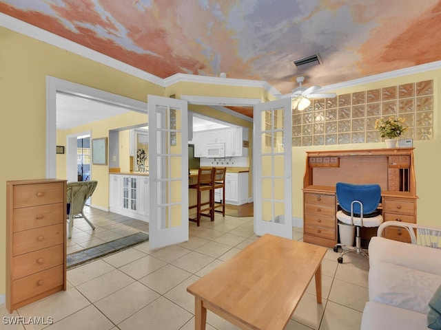 living area with visible vents, a ceiling fan, ornamental molding, french doors, and light tile patterned flooring