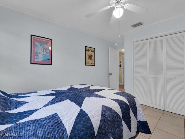 bedroom featuring crown molding, a closet, visible vents, light tile patterned flooring, and ceiling fan