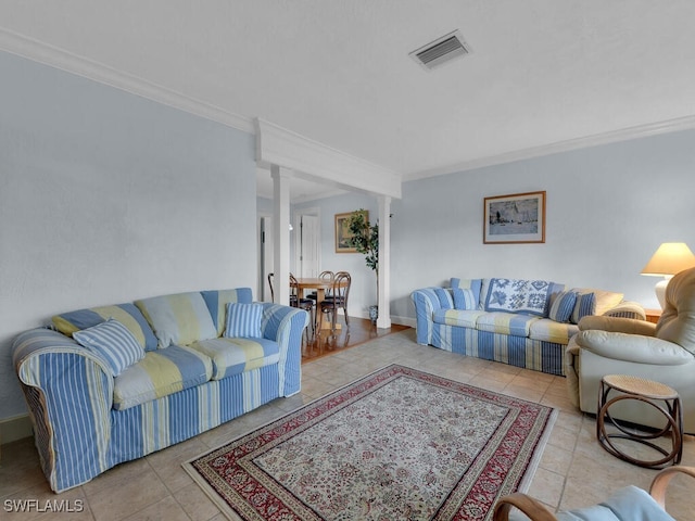 living area with tile patterned floors, baseboards, visible vents, and ornamental molding