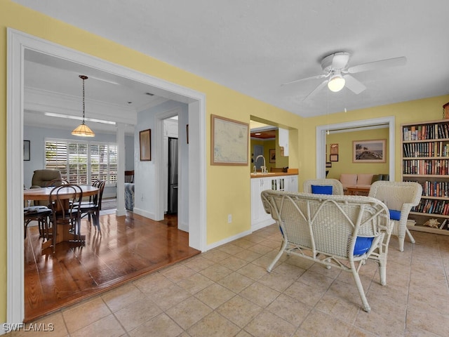 dining room with ceiling fan, baseboards, and light tile patterned flooring