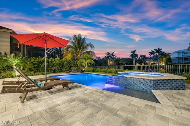 view of pool featuring a pool with connected hot tub, a patio, and fence