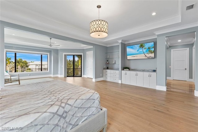 bedroom featuring visible vents, light wood-style flooring, baseboards, a raised ceiling, and access to exterior