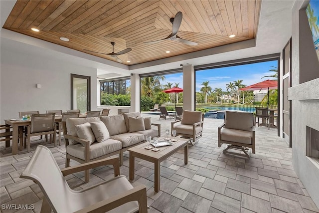 view of patio / terrace featuring an outdoor pool, a ceiling fan, outdoor dining space, and outdoor lounge area