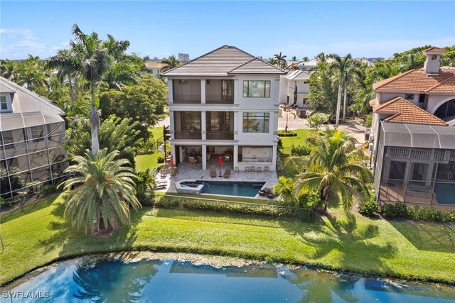 back of house with a patio, a balcony, and a yard