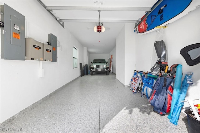 garage featuring electric panel and a garage door opener