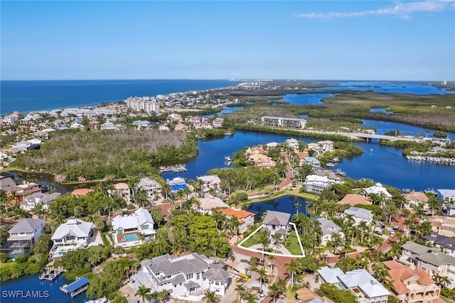 drone / aerial view with a water view and a residential view