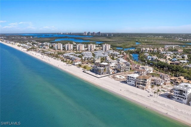 aerial view featuring a view of city, a beach view, and a water view