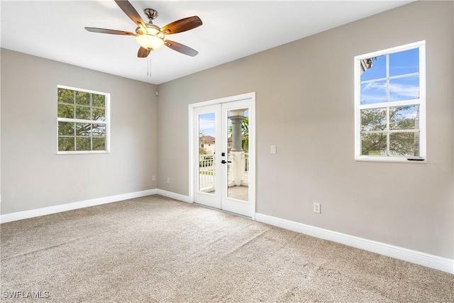 unfurnished room with french doors, carpet flooring, ceiling fan, and baseboards