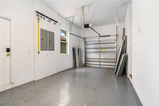 garage featuring electric panel and a garage door opener