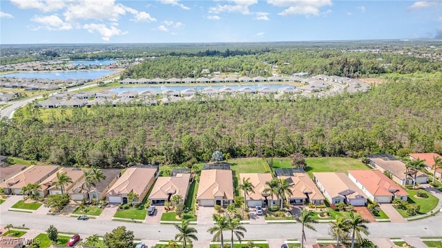 bird's eye view with a water view, a residential view, and a view of trees