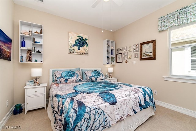 bedroom featuring light tile patterned floors, ceiling fan, and baseboards