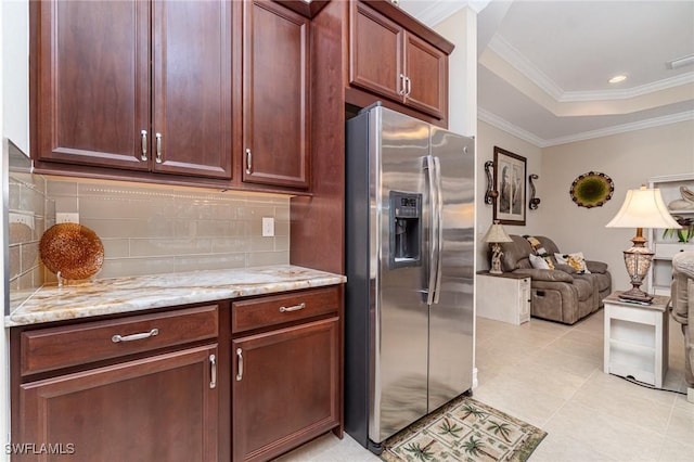 kitchen with tasteful backsplash, ornamental molding, open floor plan, and stainless steel fridge with ice dispenser