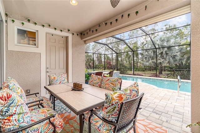 view of patio with a lanai, an outdoor pool, and ceiling fan