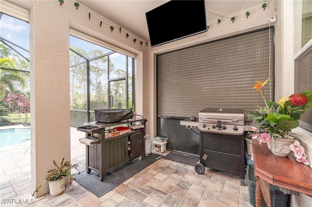 view of patio / terrace with a lanai, grilling area, and an outdoor pool