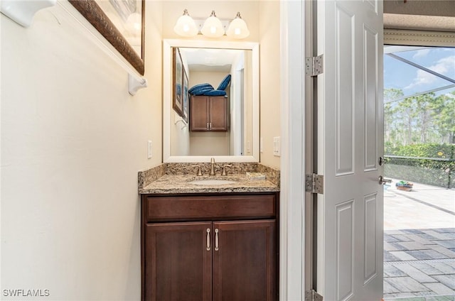 bathroom featuring brick floor and vanity