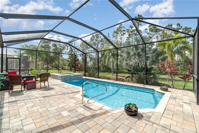 view of swimming pool with a pool with connected hot tub, glass enclosure, and a patio