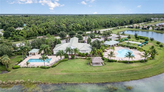 aerial view with a water view and a forest view