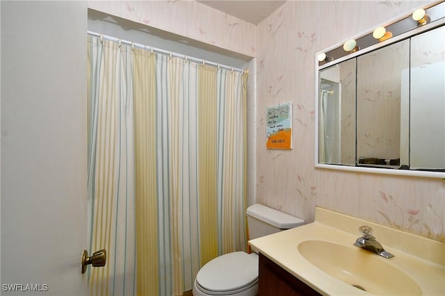 bathroom with vanity, toilet, and a shower with curtain