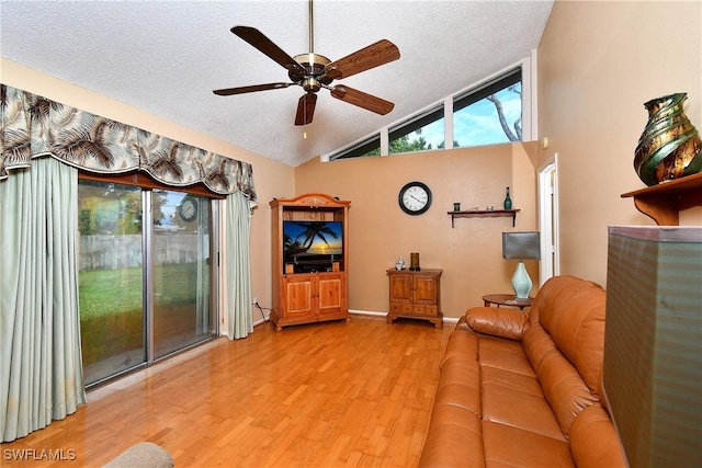 unfurnished living room featuring a textured ceiling, wood finished floors, and a healthy amount of sunlight