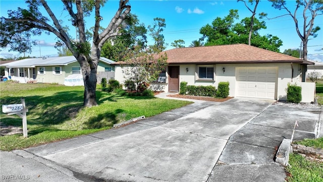 ranch-style house featuring a garage, concrete driveway, roof with shingles, stucco siding, and a front lawn