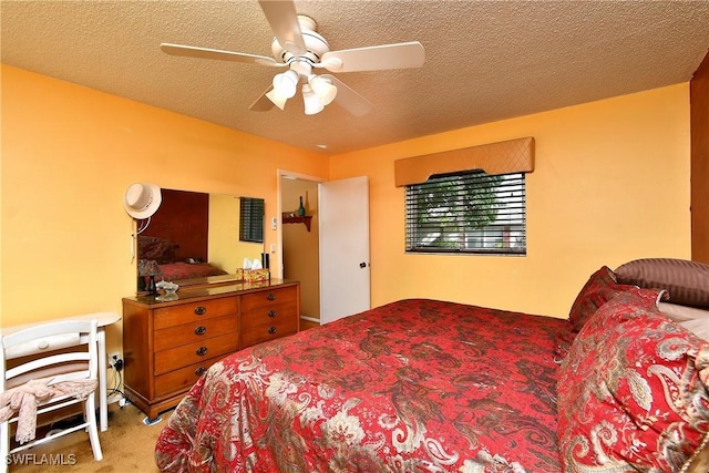 carpeted bedroom featuring a ceiling fan and a textured ceiling