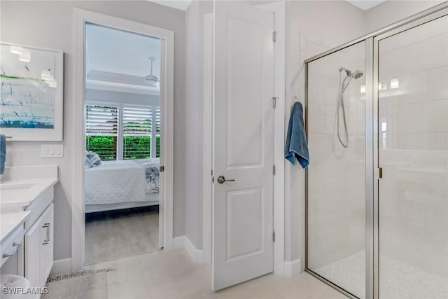 full bath with a shower stall, vanity, baseboards, and ensuite bathroom