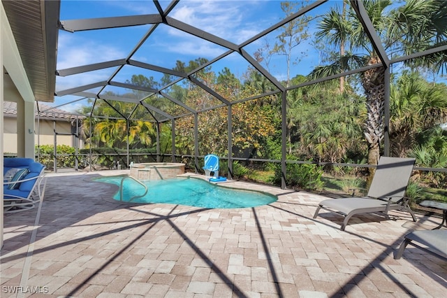 view of swimming pool with glass enclosure, a patio area, and a pool with connected hot tub