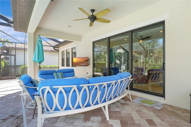 view of patio / terrace with a lanai, ceiling fan, and an outdoor living space