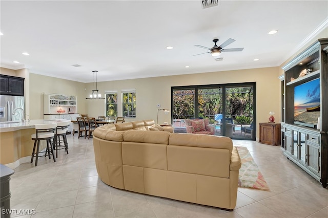 living room featuring light tile patterned floors, visible vents, ornamental molding, and recessed lighting