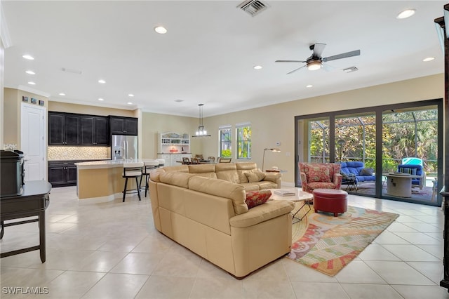 living area featuring light tile patterned floors, visible vents, and recessed lighting