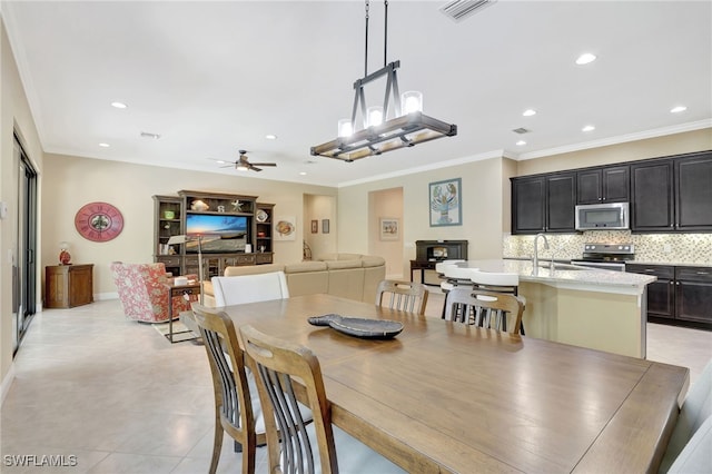 dining room with a ceiling fan, visible vents, crown molding, and recessed lighting