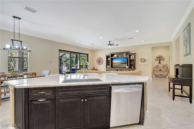 kitchen featuring open floor plan, hanging light fixtures, a kitchen island with sink, stainless steel dishwasher, and a sink