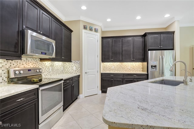 kitchen featuring light tile patterned floors, appliances with stainless steel finishes, light stone counters, ornamental molding, and a sink