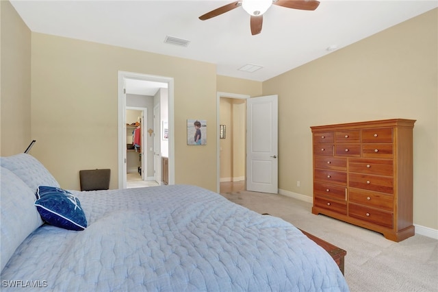 bedroom featuring light carpet, a ceiling fan, visible vents, baseboards, and a spacious closet