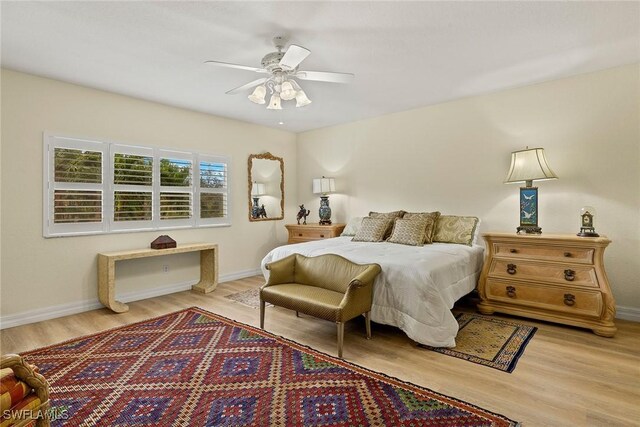 8840 Paseo De Valencia St, Fort Myers, FL 33908 - bedroom featuring a ceiling fan, baseboards, and wood finished floors