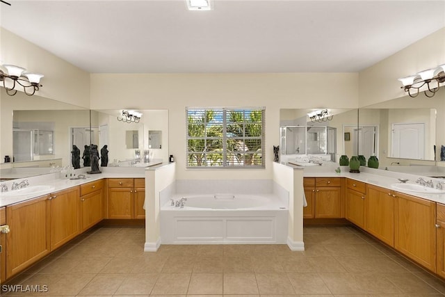 8840 Paseo De Valencia St, Fort Myers, FL 33908 - bathroom with tile patterned floors, a sink, a garden tub, a shower stall, and two vanities
