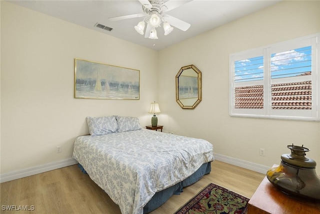 8840 Paseo De Valencia St, Fort Myers, FL 33908 - bedroom with baseboards, visible vents, ceiling fan, and wood finished floors