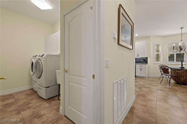 8840 Paseo De Valencia St, Fort Myers, FL 33908 - washroom with a notable chandelier, cabinet space, visible vents, independent washer and dryer, and baseboards